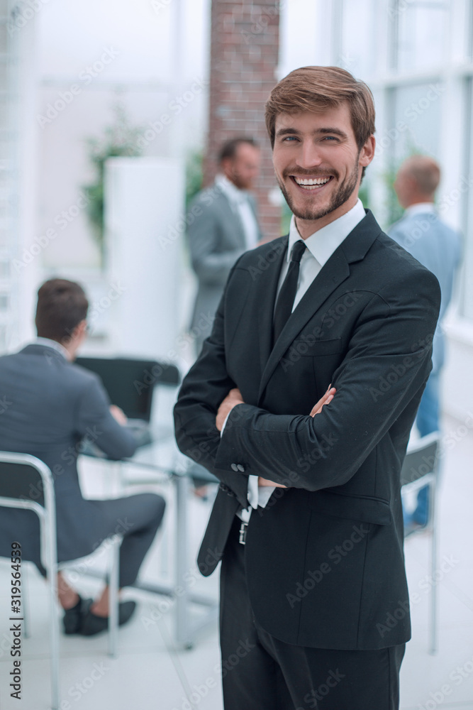 confident young businessman standing in the office