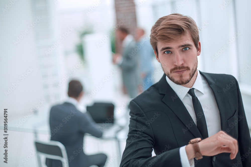 serious businessman looking at his wrist watch. serious businessman looking at his wrist watch.