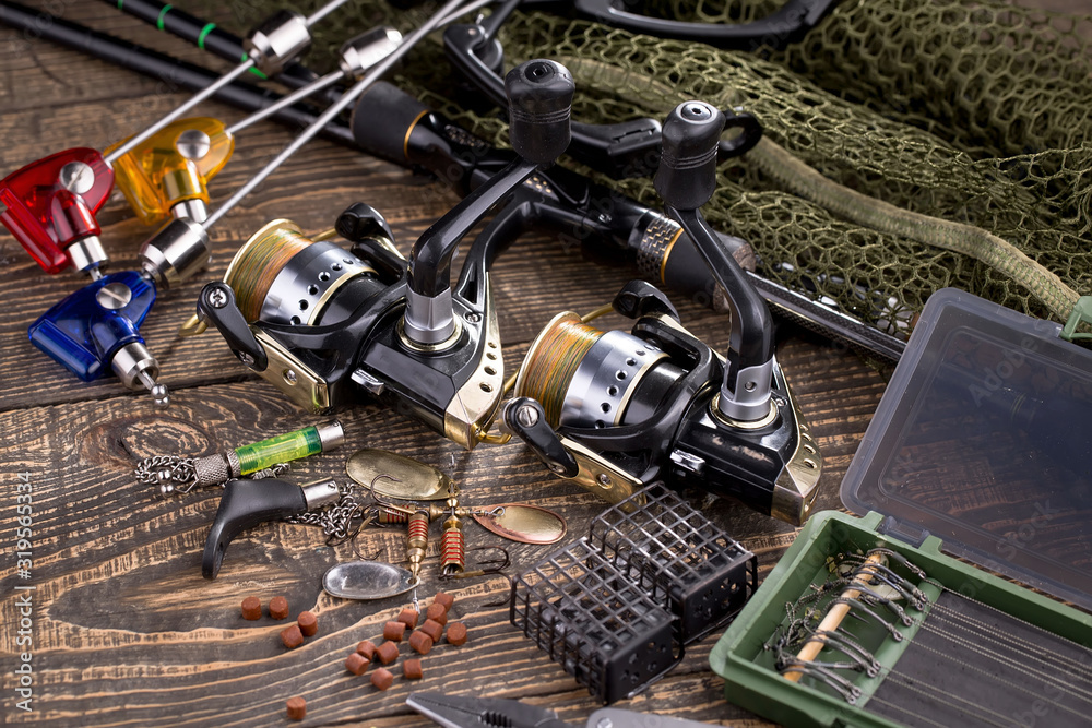 fishing tackle on a wooden table. toned image