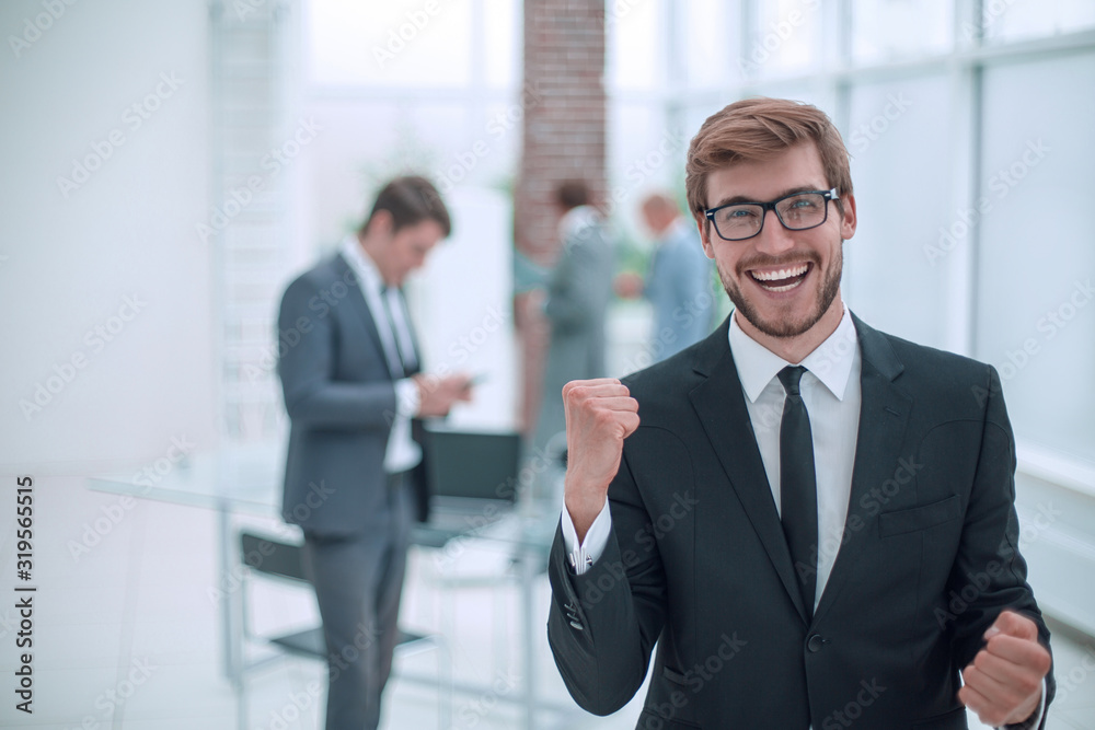 close up. happy confident businessman standing in office