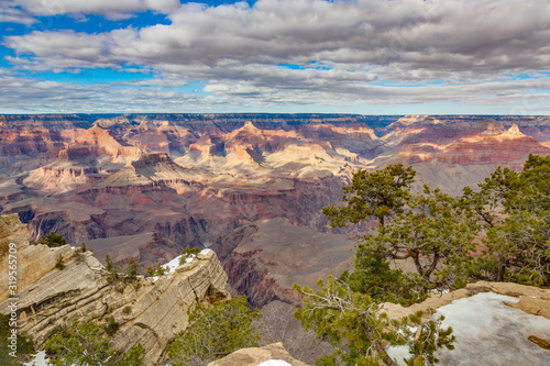 Panoramic view from south cliff of Grand Canyon with dramatic cloud formations in winter