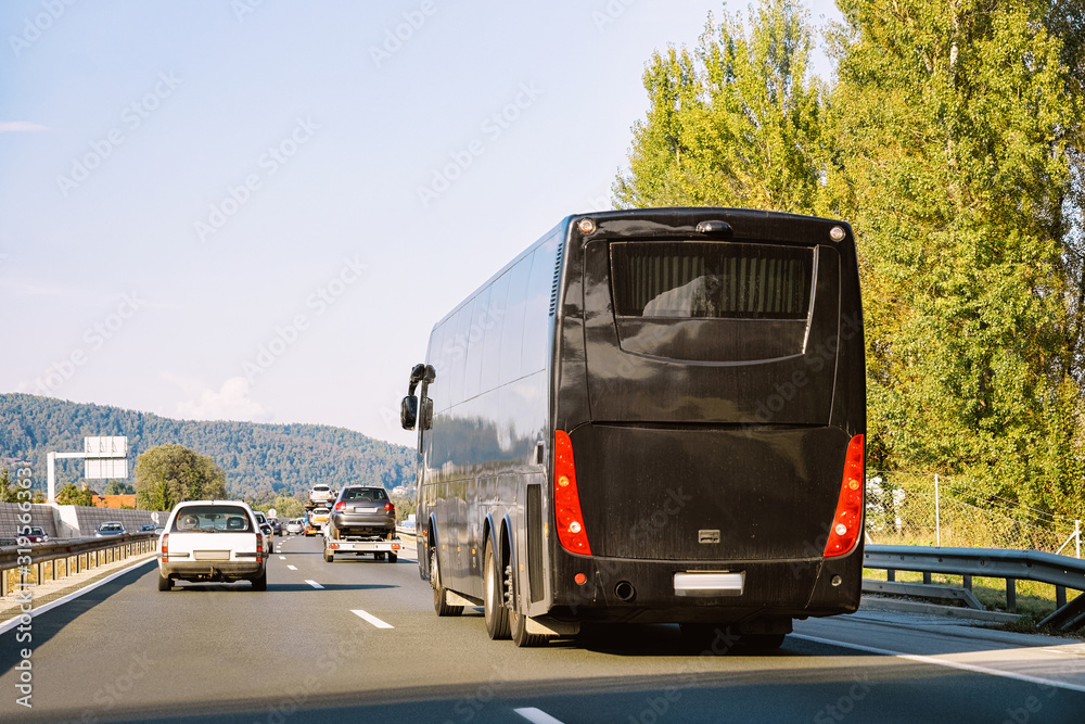 Black Tourist bus in the road in Poland. Travel concept.