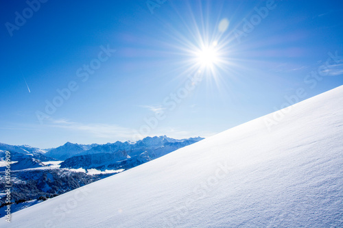 deep snow untouched swiss mountain panorama against blue sky with copy space