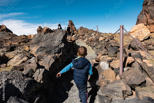 little boy climbs a volcano