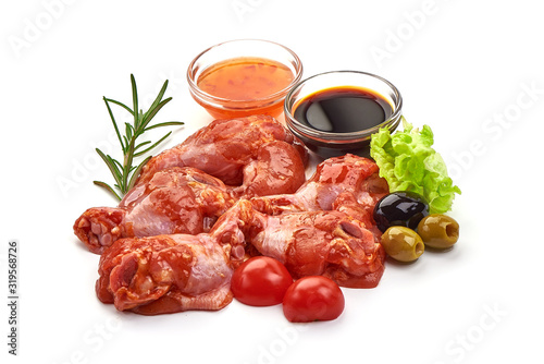 Raw chicken legs in a barbecue marinade, isolated on white background