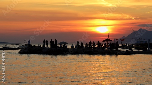 Silhouettes and sunset at the sea