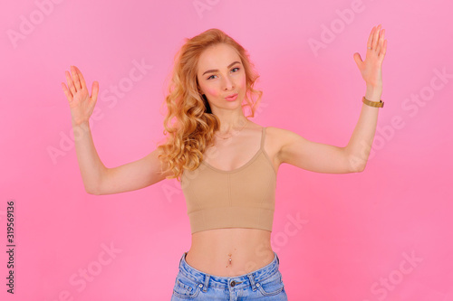 Gorgeous young blonde posing on a bright background