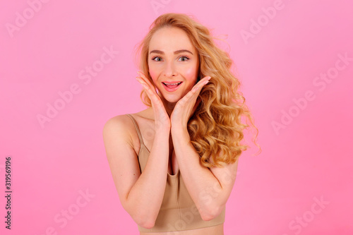 Gorgeous young blonde posing on a bright background