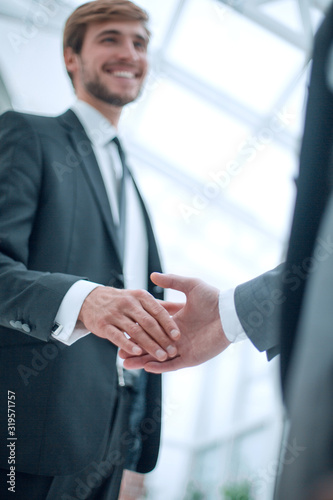 image of business people holding out their hands for a handshake. © ASDF