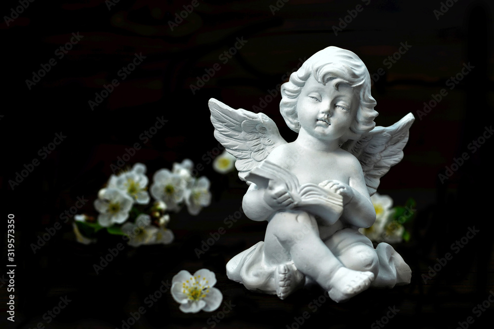 Sympathy card. Guardian angel and spring flowers isolated on black background Sympathy card. Guardian angel and spring flowers isolated on black background