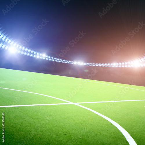 Football field on a stadium with lights and flashes at night