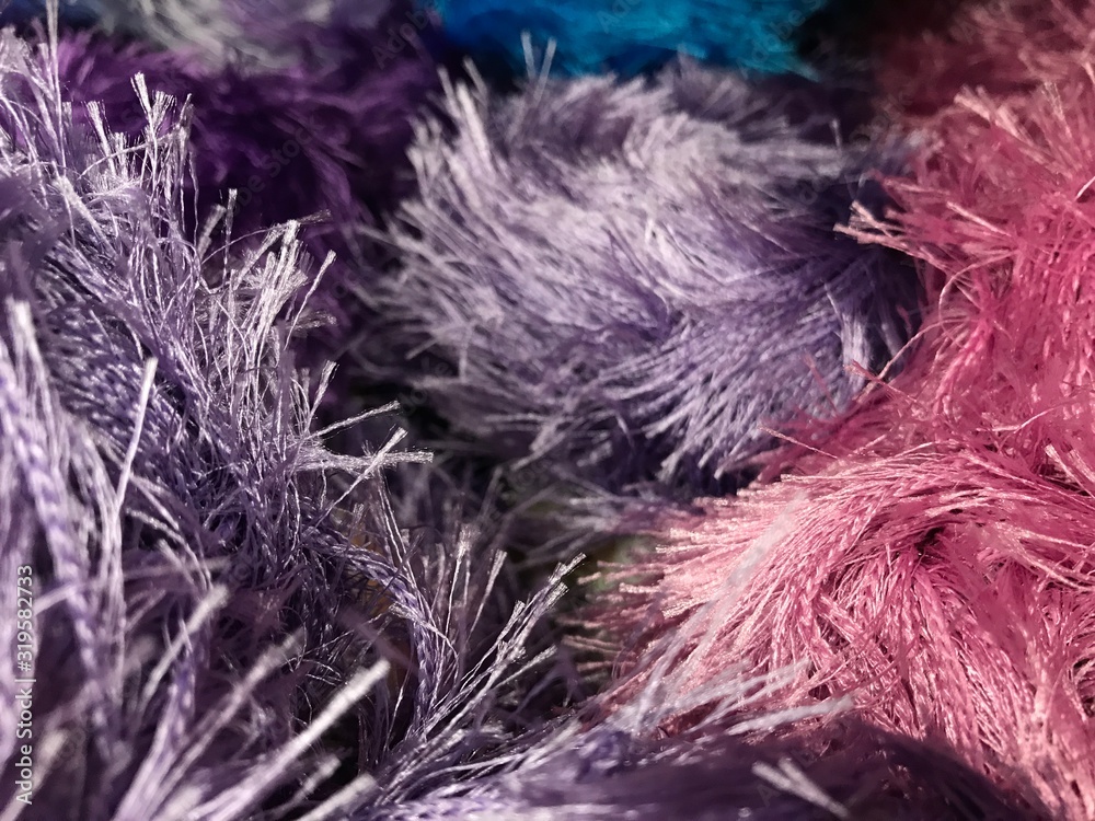 Fototapeta premium Texture of different sharpness from fluffy bright yarn of lilac and pink colors. Mobile photo with store lighting.