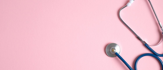 Stethoscope on pink background with copy space. Cardiac heart checkup concept. Medical banner design template for medical center, hospital, clinic