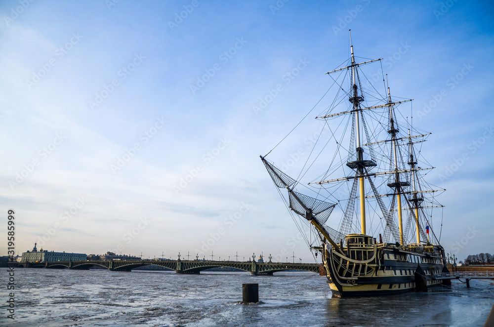 The sailing vessel  on a frost Neva river moored to Petrograd quay of St.-Petersburg. Frigate Grace. Russia