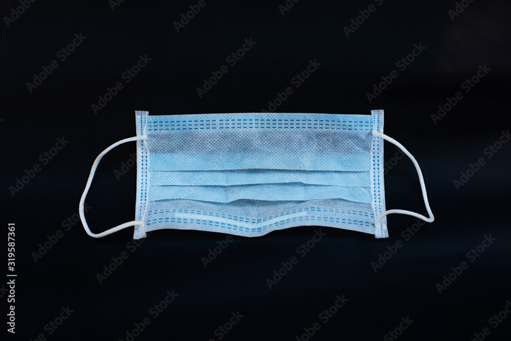 Dust and virus protection mask isolated from dark background Dust and virus protection mask isolated from dark background