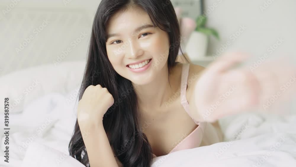 Beautiful portrait young asian woman smile happy and cheerful gesture hello with emotion positive waving hand in the home, girl confident gesture saying hi or greeting with excited, lifestyle concept. Beautiful portrait young asian woman smile happy and cheerful gesture hello with emotion positive waving hand in the home, girl confident gesture saying hi or greeting with excited, lifestyle concept.