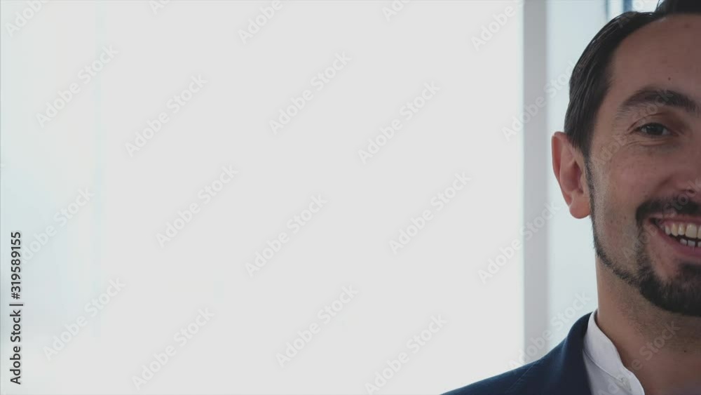 Crop. Male business worker is talkinf and smiling. Successful man. Copy space. Blurred white background. Close up. 4K. Crop. Male business worker is talkinf and smiling. Successful man. Copy space. Blurred white background. Close up. 4K.