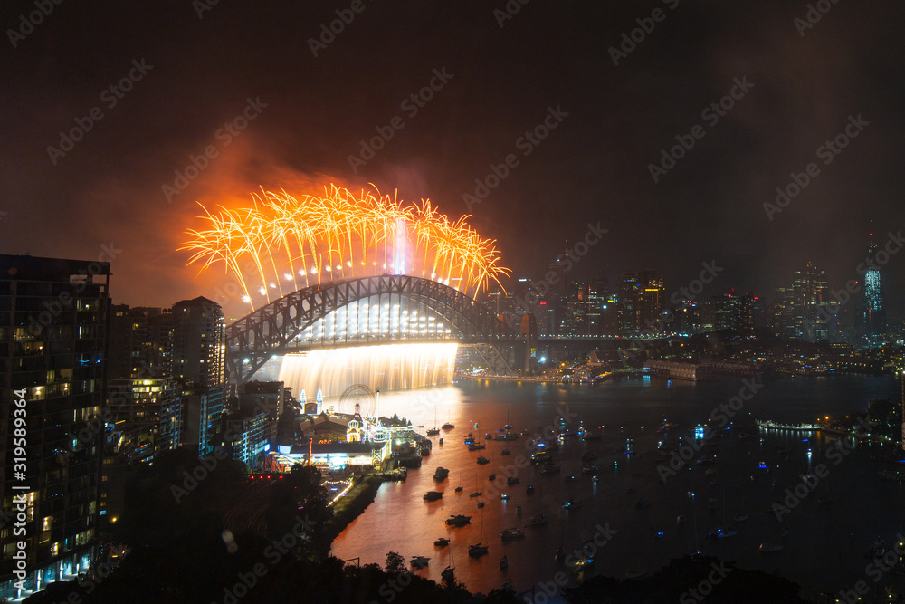 Fototapeta premium Orange fireworks above Sydney Harbour Bridge for New Year.