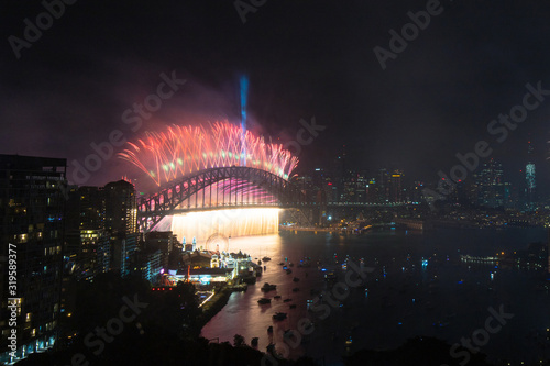 Red fireworks above Sydney Harbour Bridge for New Year.