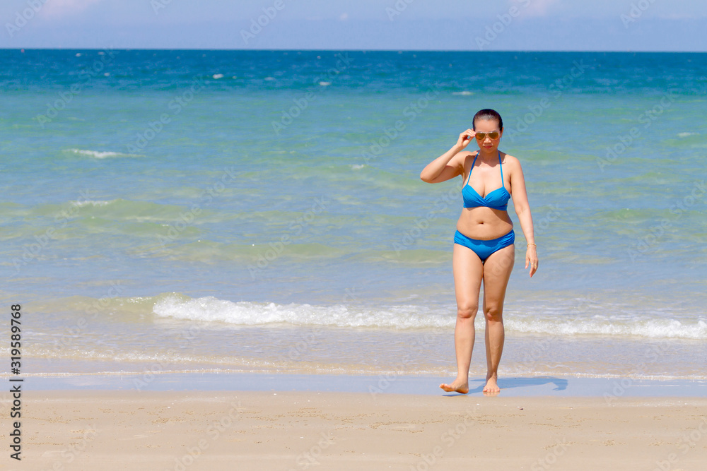 Woman and bikini blue sexy with sunlight on beach