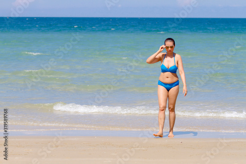 Woman and bikini blue sexy with sunlight on beach