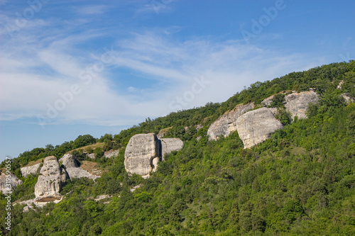 Rocky formations. Rocky terrain. Limestone skaa. Ancient gorge in the mountains. Natural landscape in a southern country. A tourist place to stay. photo