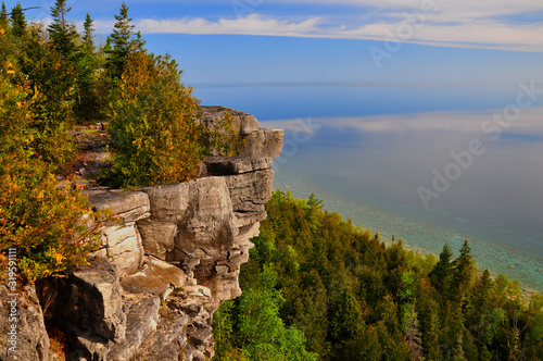 Limestone cliff face with stunted cedar trees along the Bruce Trail near Lions Head, Ontario, Canada photo