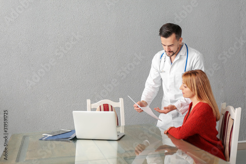 Male doctor working with pa...