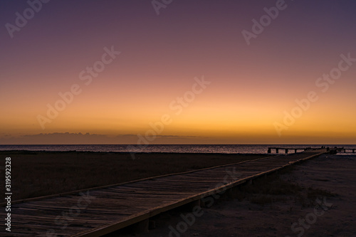 Wooden dock  with beautiful sunset at the background. Coche Island, Venezuela © DOUGLAS
