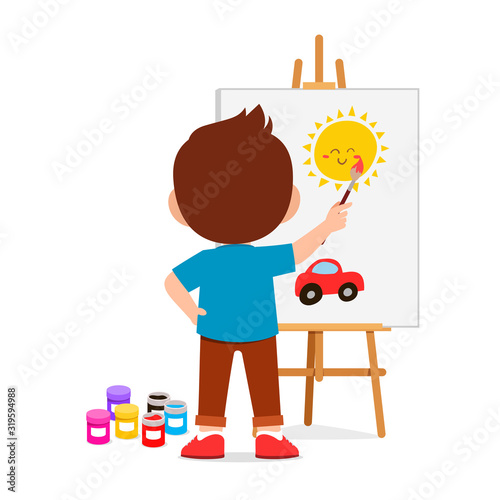 happy cute little kid boy draw on canvas