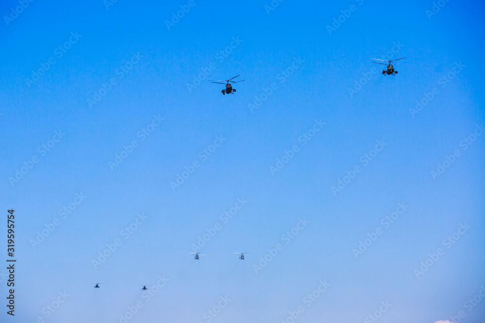 Russian military helicopter during flight in the air, a squadron formation of helicopters