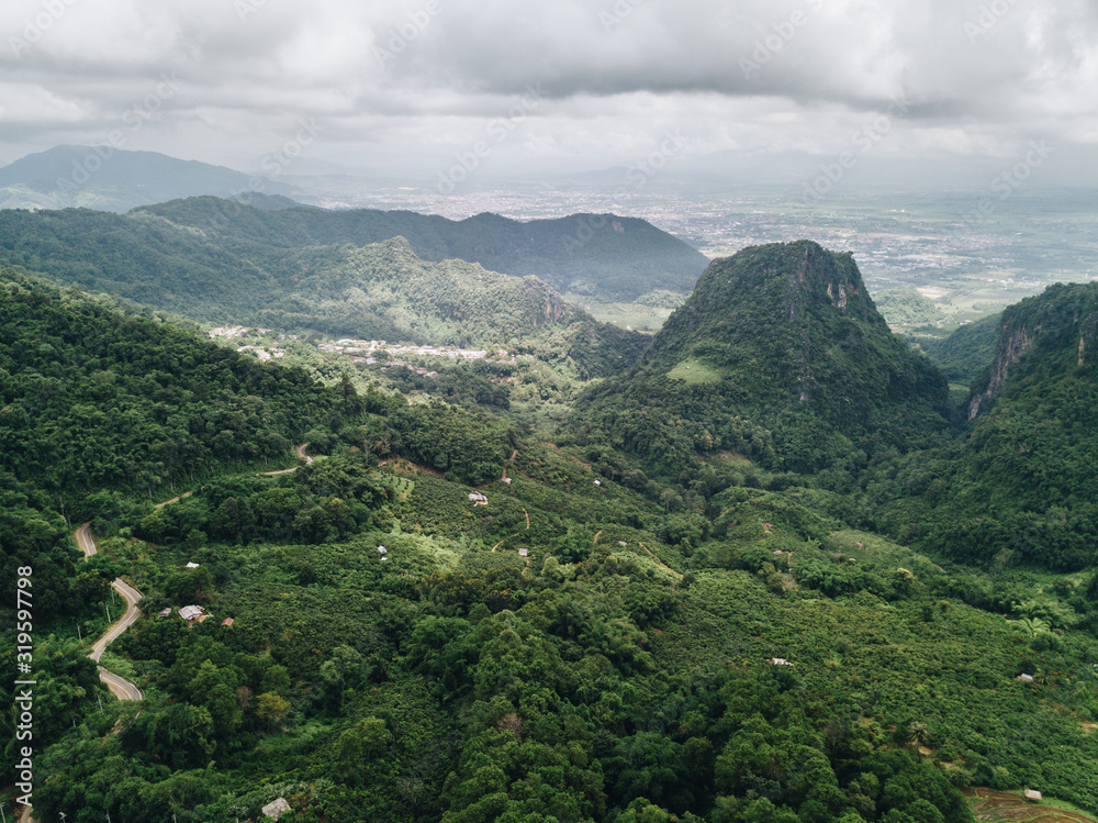 Aerial view of beautiful landscape of Doi Pha Hi an intricate mountain range in Mae Sai district of Chiang Rai province of Thailand in rainy season.