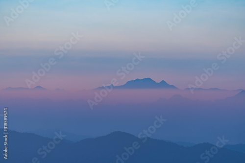 Mountain complex with misty or smoke pollution from wildfire during morning at the northern region of Thailand. © Tanongsak