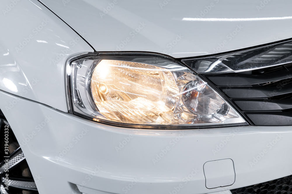 White car headlights. Exterior detail. Close up detail on one of the LED headlights modern car..
