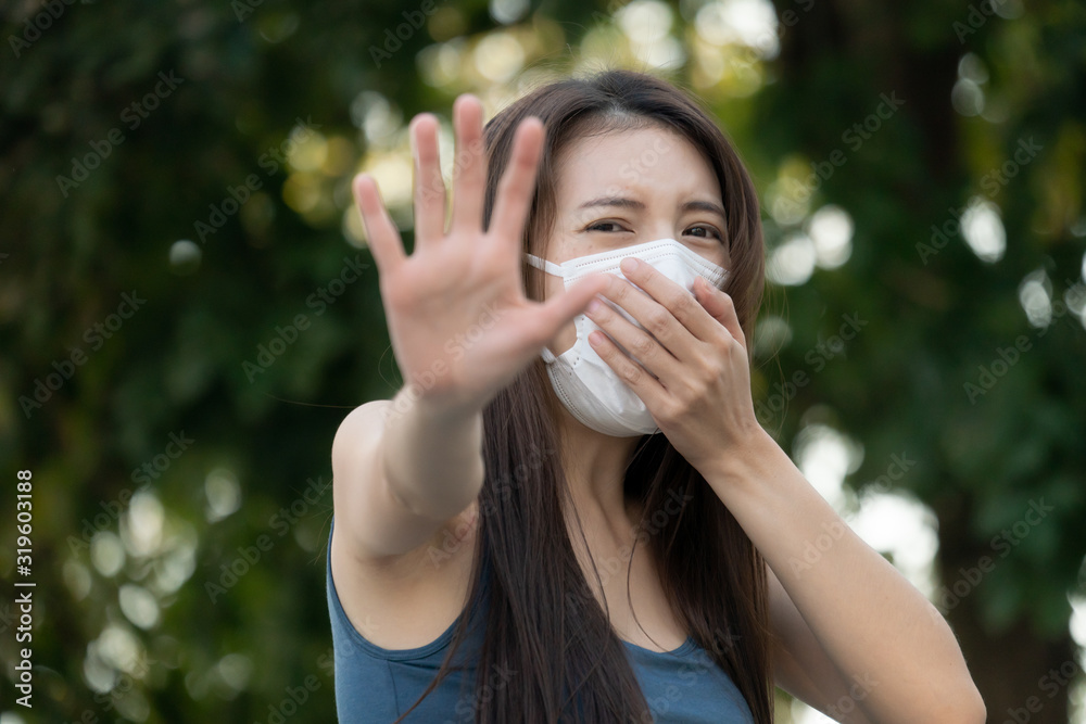 Woman with unhappy face, holds two hands in front of her, sign to stop, Stop sign. She wearing protective mask. Woman with unhappy face, holds two hands in front of her, sign to stop, Stop sign. She wearing protective mask.