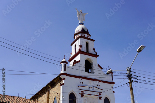 Amazing view of the main town square in Zipaquira, where people visit the church and the local market in the streets with colonial architecture.