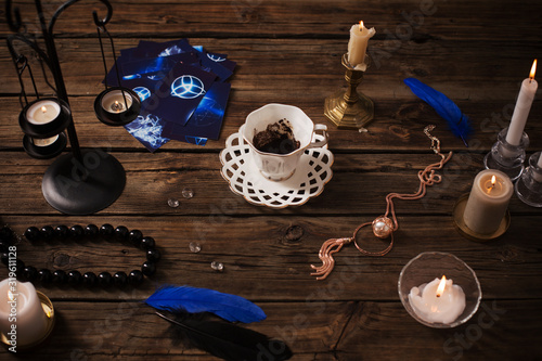 fortune-telling with  cup of coffee and fortune-telling cards on old wooden table photo