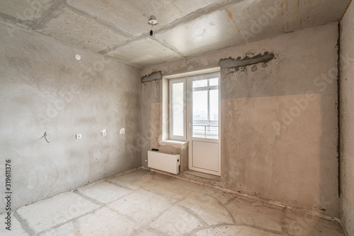 Empty interior for design, gray concrete wall. Empty room. Space for text and picture. Concrete walls, slabs, interior of a new residential building. Partitions in a new apartment.