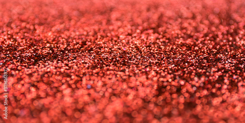 Blur red sparkle background. Defocused christmas texture.