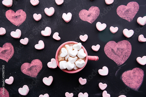cup of hot chocolate with a heart shaped marshmallow. 