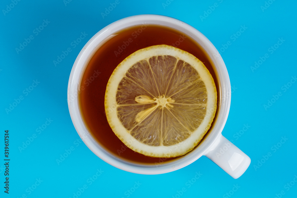 Top view, cup of a lemon tea over blue background. Top view, cup of a lemon tea over blue background.