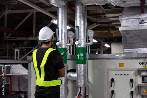 Technician daily pressure check controls system for security functions in utility room at factory. CHR-CHS system