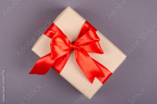 Gift box on dark background composition, present with ribbon and bow.