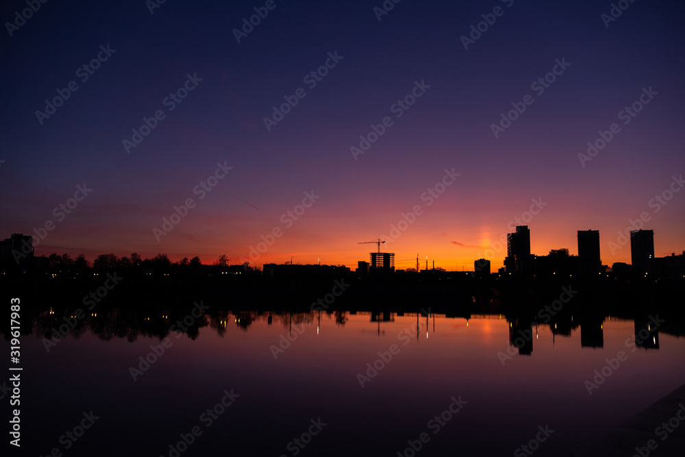 Sunrise in a big city over a river