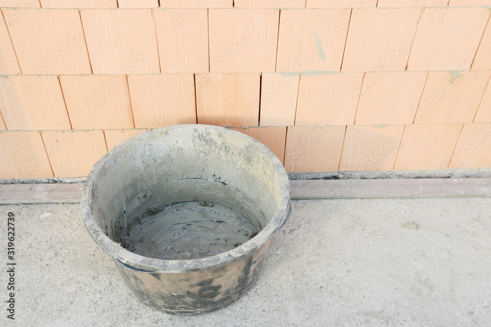 mason bucket on construction site on construction site in front of building stones mason bucket on construction site on construction site in front of building stones
