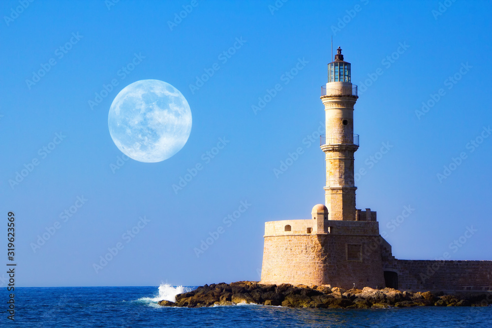 Beautiful morning , sunrise in Chania, Crete, Greece. Full moon over the Lighthouse of an old port and venetian harbour. Travel background