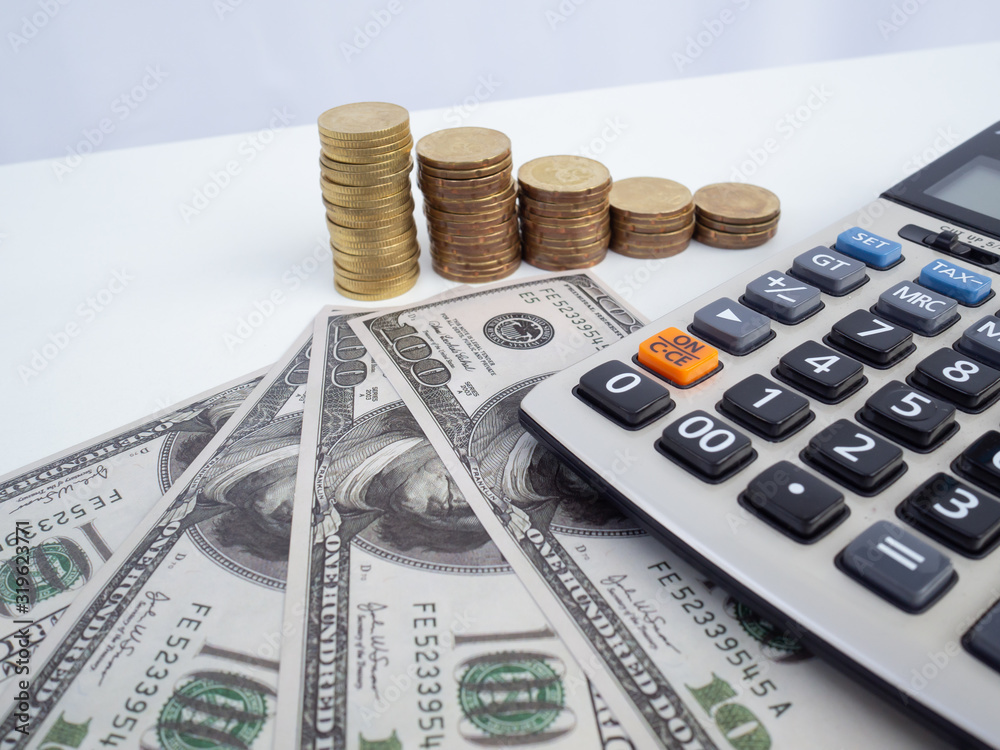 Stethoscope over pile of dollar and calculator. Savings, bank..Financial analysis concept. Stethoscope over pile of dollar and calculator. Savings, bank..Financial analysis concept.