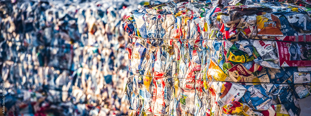 Recycling and storage of waste for further disposal, trash sorting. Picture of recycled plastic waste pressed to bales. Plastic bottles,compressed - obrazy, fototapety, plakaty 