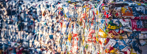 Recycling and storage of waste for further disposal, trash sorting. Picture of recycled plastic waste pressed to bales. Plastic bottles,compressed photo