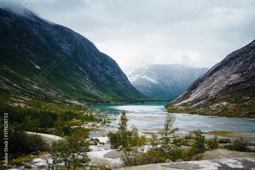 Picturesque landscape mountains of Norway. Beautiful view of the lake. Rocky shore of mountain lake in the morning. Travelling, lifestyle, wild nature concept.